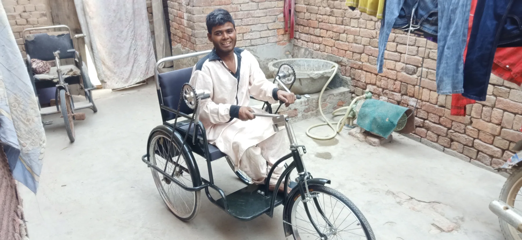 A person seated on a mobility tricycle