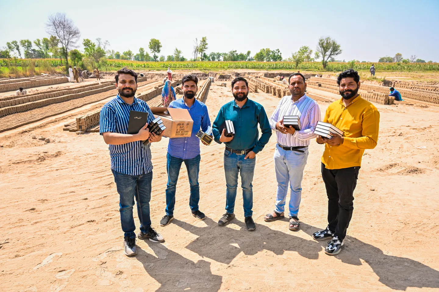 Team members with Bibles at an outdoor gospel outreach