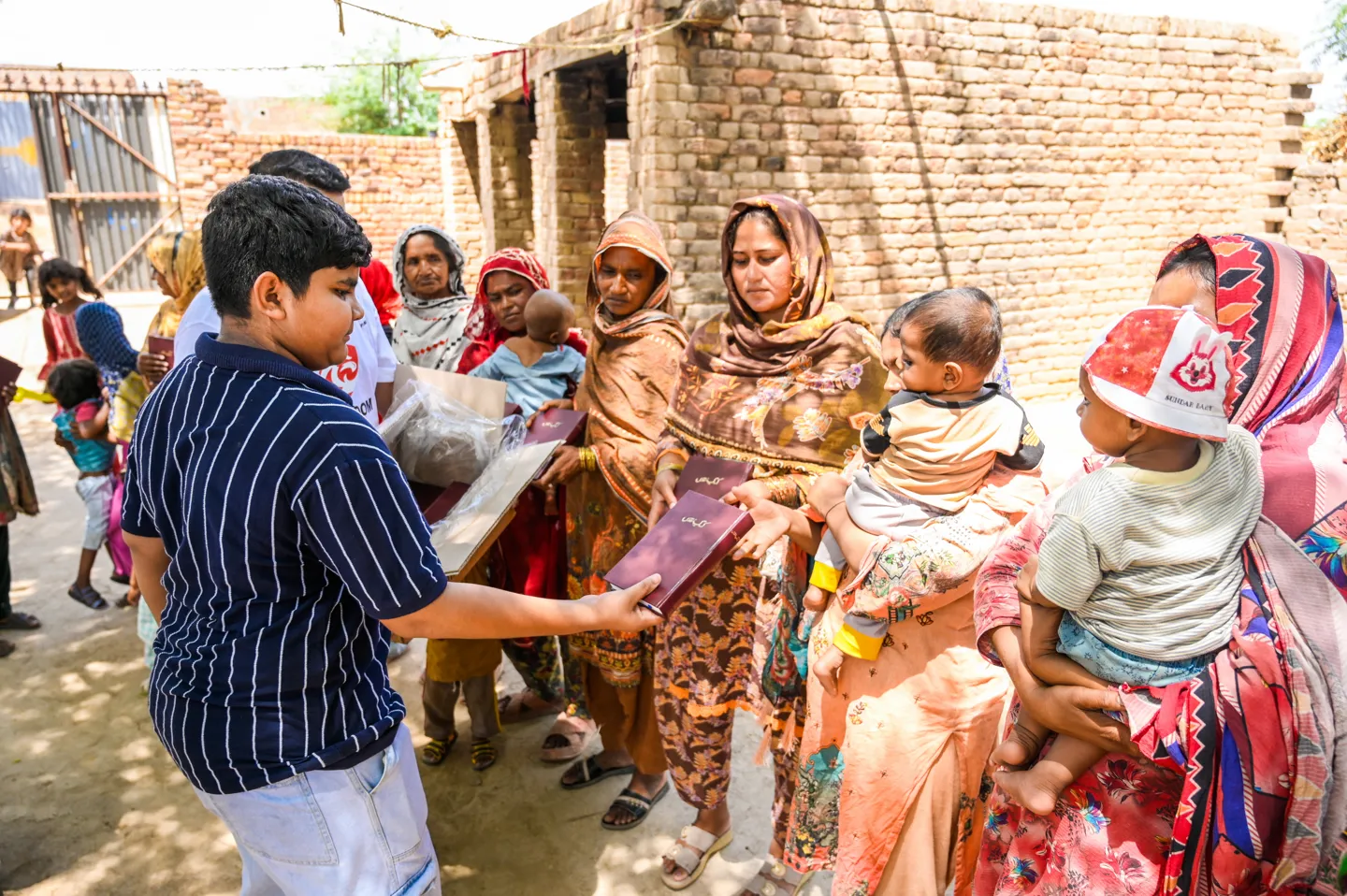 Bibles being handed to families at a distribution