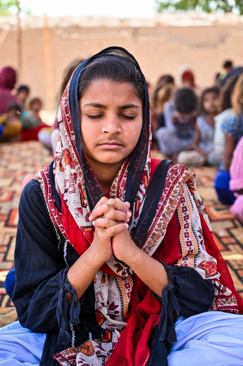 A child praying with hands together