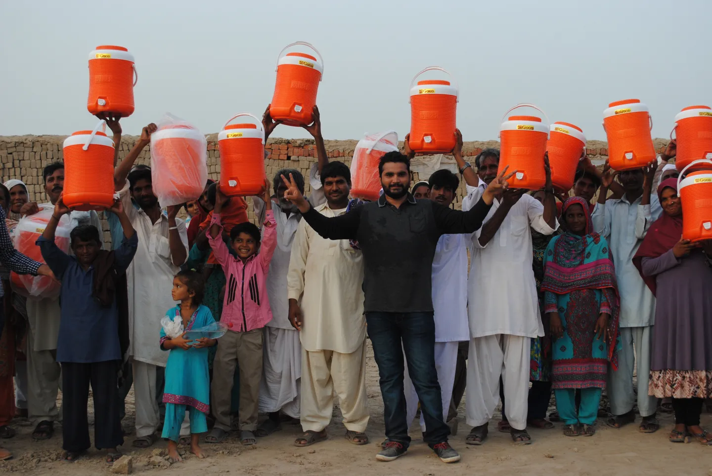 A community holding up the drinking-water coolers provided by the ministry